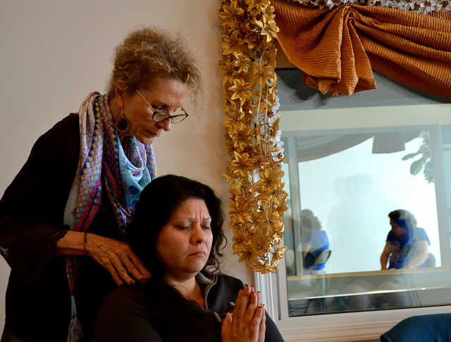 Marydale Pecora gives Sandra Delgado an energy attunement at her Reiki share session. Photo courtesy of Brianna Sacks