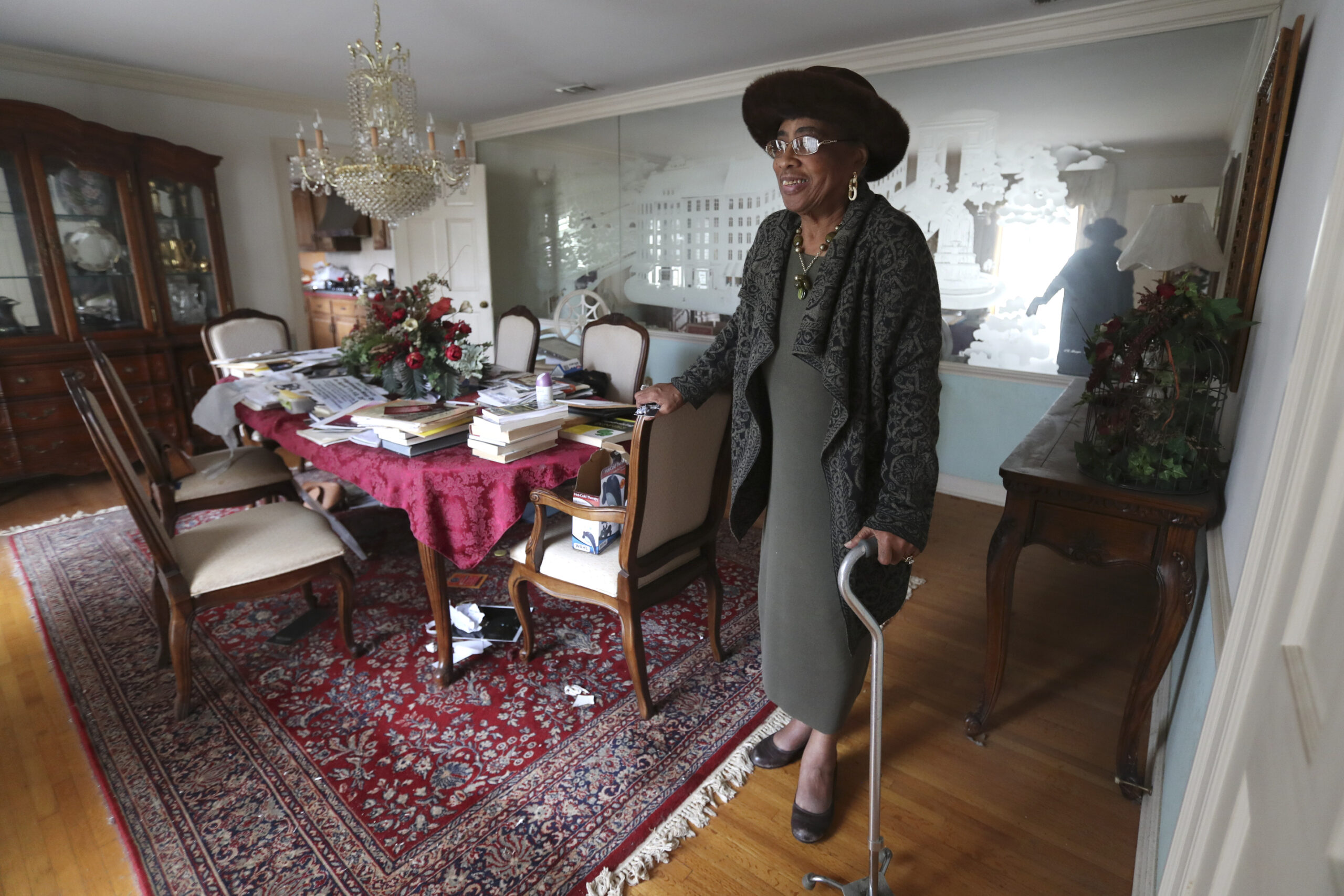 Mother Mary Patterson, poses at her dining room table in her Memphis, Tenn., home Dec. 1, 2021. The material on the table was used by Patterson in her recent campaign to post historical markers about Church of God in Christ leaders. In the Church of God in Christ, where only men have traditionally been recognized as ordained ministers or as bishops, women like Patterson have nevertheless played key roles in its Women's Department — which oversees auxiliaries — and in other ways. (AP Photo/Karen Pulfer Focht)