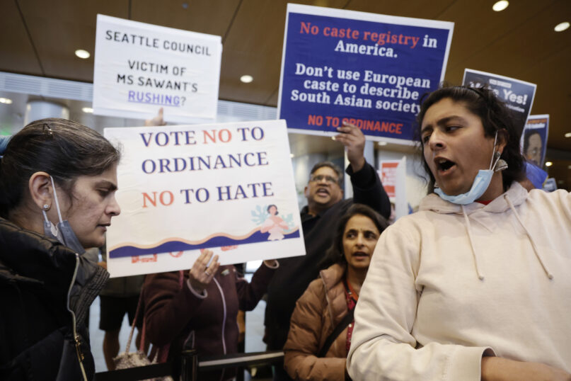 Supporters and opponents of a proposed ordinance to add caste to Seattle’s anti-discrimination laws attempt to out-voice each other during a rally at Seattle City Hall, Feb. 21, 2023, in Seattle. (AP Photo/John Froschauer)