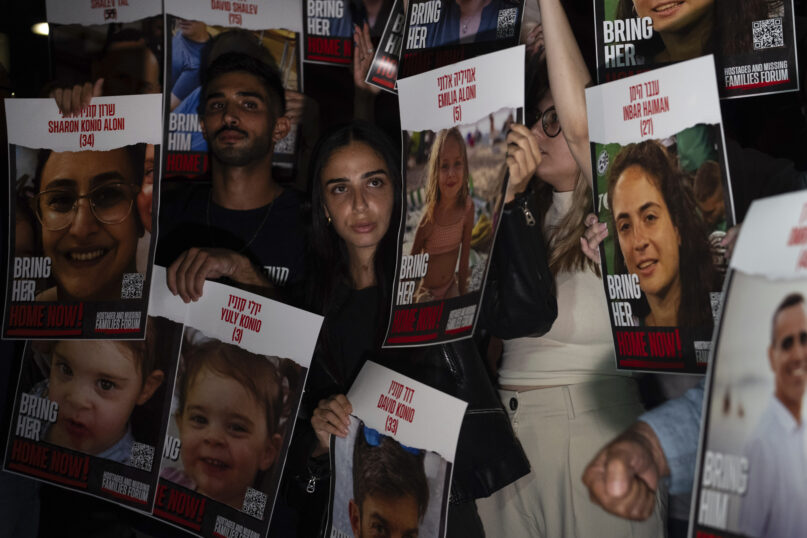 Relatives of people kidnapped by Hamas militants hold the pictures of their loved ones during a protest in Tel Aviv, on Saturday, Oct. 21, 2023. Relatives of people kidnapped by Hamas militants and supporters organize a protest calling for the return of more than 200 hostages held in Gaza for two weeks. (AP Photo/Petros Giannakouris)