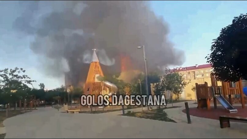 This photo taken from video released by Golos Dagestana shows smoke rising after an attack in Makhachkala, republic of Dagestan, Russia, June 23, 2024. Russian state news agency RIA Novosti says that armed militants attacked two Orthodox churches, a synagogue and a traffic police post in Russia’s southern republic of Dagestan, killing a priest and six police officers. (Golos Dagestana via AP)