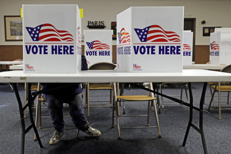 A voter fills in a ballot in the presidential primary election at the Summit View Church of the Nazarene, March 10, 2020, in Kansas City, Mo. (AP Photo/Charlie Riedel)