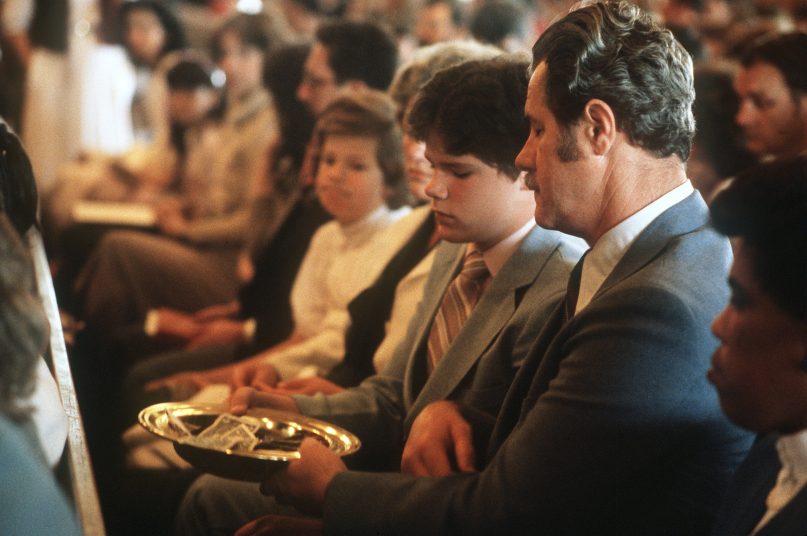 The collection plate is passed during an Easter Sunday service. Photo courtesy of the National Archives