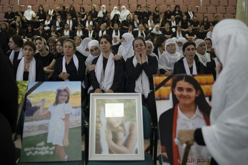 Members of the Druze minority attend a memorial ceremony for the children and teens killed in a rocket strike in the village of Majdal Shams, in the Israeli-annexed Golan Heights. AP Photo/Leo Correa