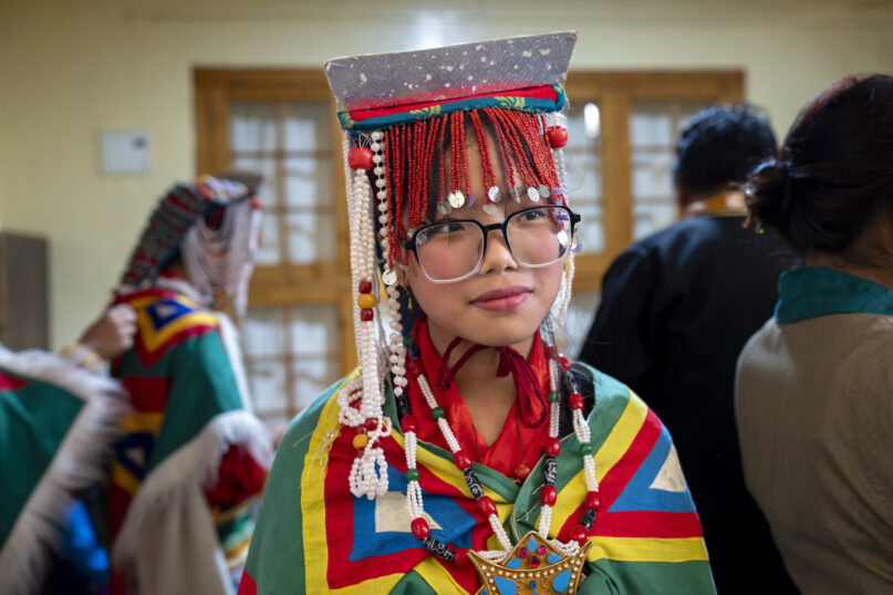 Tsering Dolma, a school girl, gets ready to perform a traditional dance at an event to celebrate the 89th birthday of Tibetan spiritual leader the Dalai Lama at the Tsuglakhang temple in Dharamshala, India, Saturday, July 6, 2024. (AP Photo/Ashwini Bhatia)