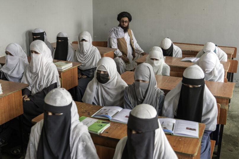 FILE - Afghan girls attend a religious school that remained open since the 2021 Taliban takeover, in Kabul, Afghanistan, Aug 11, 2022. The country’s Taliban rulers ordered women nationwide to stop attending private and public universities in December 2022. The Taliban also banned girls from middle school and high school, barred women from most fields of employment and ordered them to wear head-to-toe clothing in public. Women are also banned from parks and gyms. (AP Photo/Ebrahim Noroozi, File)