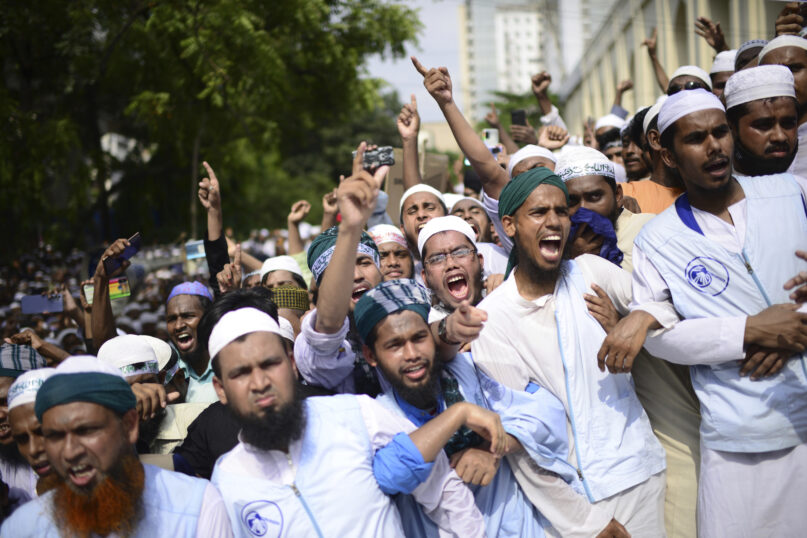 Muslims shout slogans against Nupur Sharma, a spokesperson of India's governing Hindu Nationalist Party as they react to the derogatory references to Islam and the Prophet Muhammad made by her, during a protest outside a mosque in Dhaka, Bangladesh, Friday, June 10, 2022. Thousands of people marched in Bangladesh's capital on Friday to urge Muslim-majority nations to cut off diplomatic ties with India and boycott its products unless it punishes two governing party officials for comments deemed derogatory to Islam's Prophet Muhammad. (AP Photo/Mahmud Hossain Opu)