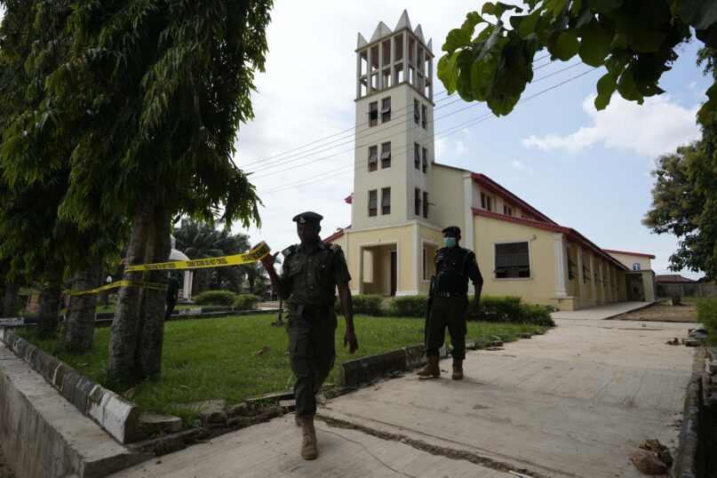 Nigerian police officers put tape around St. Francis Catholic Church in Owo, Nigeria, Monday, June 6, 2022, a day after an attack that targeted worshippers. (AP Photo/Sunday Alamba)