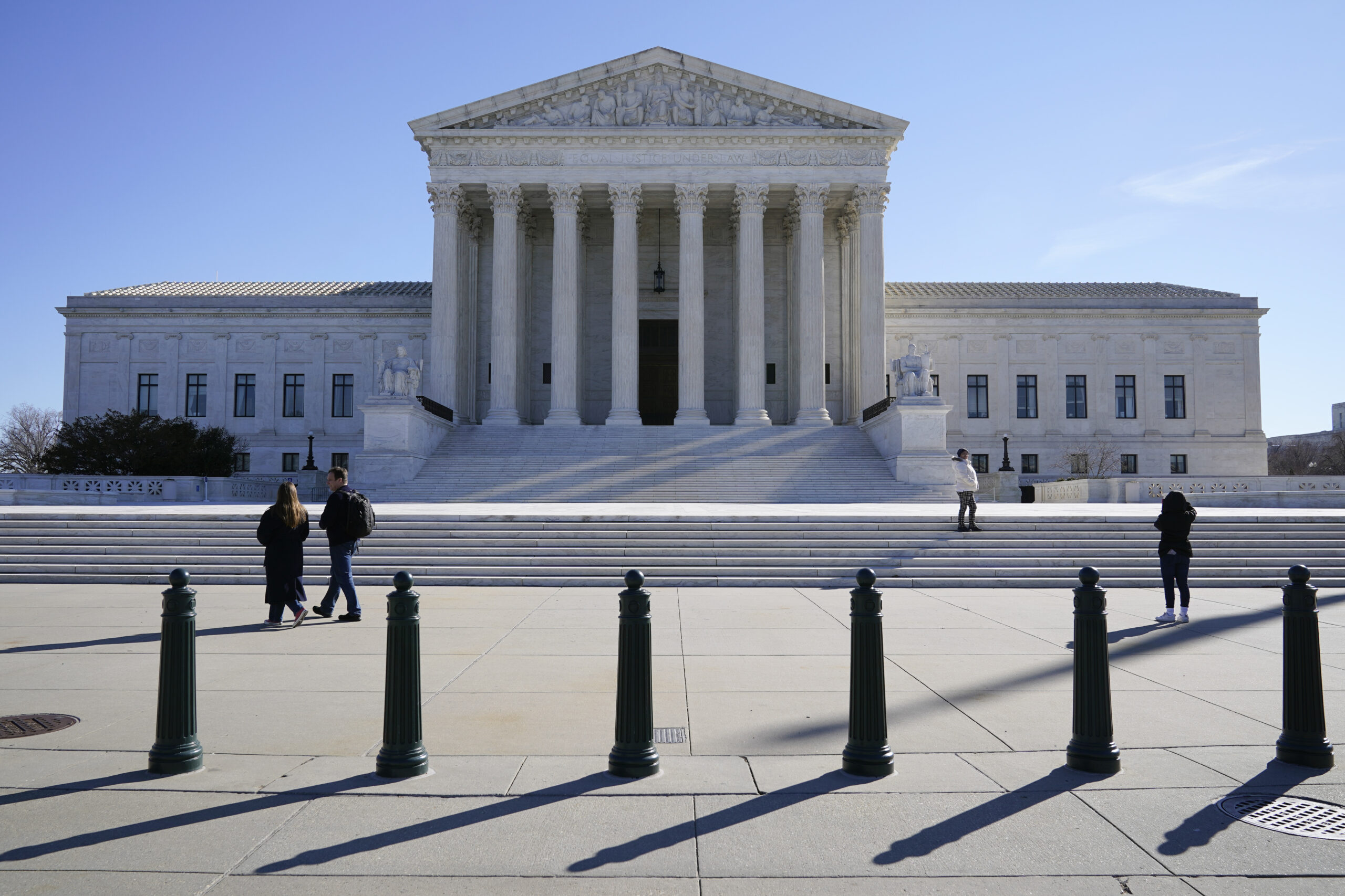 Visitors walk outside the Supreme Court building on Capitol Hill in Washington, Feb. 21, 2022. (AP Photo/Patrick Semansky, File)