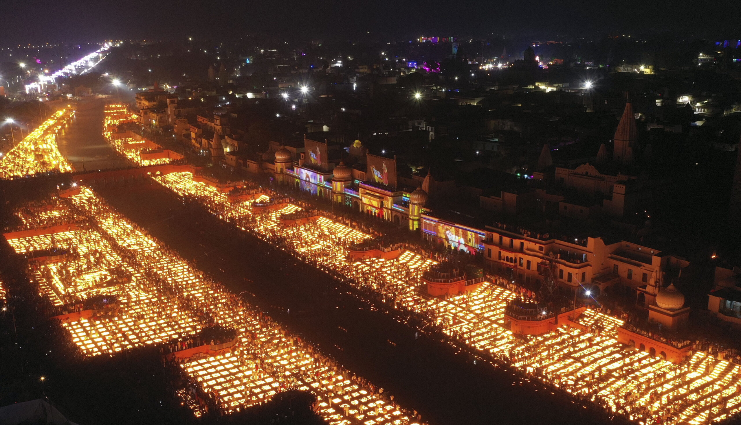 People light lamps on the banks of the river Saryu in Ayodhya, India, Wednesday, Nov. 3, 2021. Millions of people across Asia are celebrating the Hindu festival of Diwali, which symbolizes new beginnings and the triumph of good over evil and light over darkness. The celebrations were especially spectacular in Ayodhya city in northern Uttar Pradesh state, where over 900,000 earthen lamps were lit at the banks of the Saryu River as desk fell Wednesday. Hindus believe the city is the birthplace of god Ram. (AP Photo/Rajesh Kumar Singh)