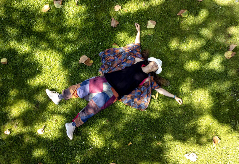 Russian artist Sasha Skochilenko, freed in a prisoner swap this month, relaxes on the grass in a park in Koblenz, Germany, Saturday, Aug. 10, 2024. (AP Photo/Michael Probst)