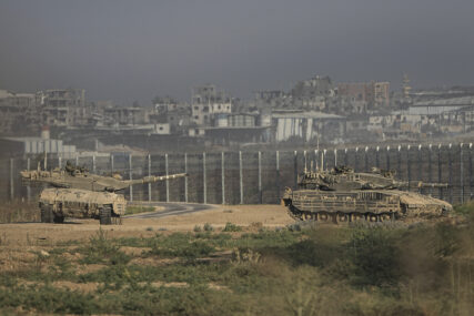 Israeli tanks stand near the Israel-Gaza border, as seen from southern Israel, Sunday, July 14, 2024. (AP Photo/Tsafrir Abayov)