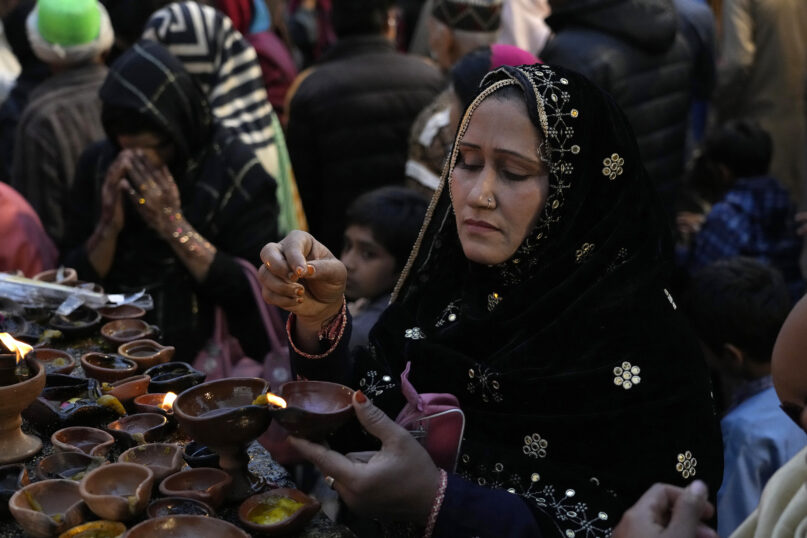 Pakistani Muslims devotees light lamps at the shrine of Muslim Sufi saint Shah Hussain, to pay tribute during a three-day annual festival in Lahore, Pakistan, Saturday, March 2, 2024. Thousands of pilgrims arrived from different cities to attend the Urs, or the festival. (AP Photo/K.M. Chaudary)