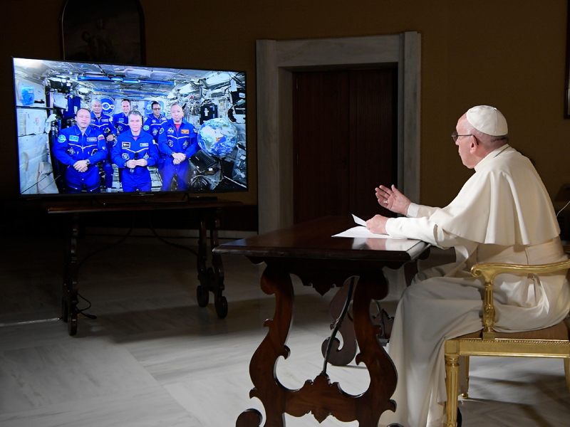 Pope Francis speaks to the crew aboard the International Space Station from the Vatican on Oct. 26, 2017. Francis' hookup Thursday marked the second papal phone call to space: Pope Benedict XVI rang the space station in 2011 and peppered its residents with questions about the future of the planet and the environmental risks it faced. (L'Osservatore Romano/Pool Photo via AP)