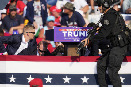 Republican presidential candidate former President Donald Trump is surrounded by U.S. Secret Service at a campaign event in Butler, Pa., on Saturday, July 13, 2024. (AP Photo/Gene J. Puskar)