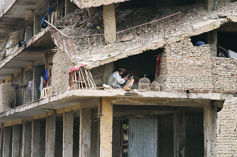 A woodworker in a damaged building in Afghanistan. Photo courtesy of The Voice of the Martyrs