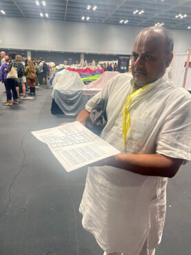 Karunakara Reddy holds a birth chart of Amma, Wednesday, Aug. 7, 2024, at Javits Convention Center in New York. (RNS photo/Richa Karmarkar)