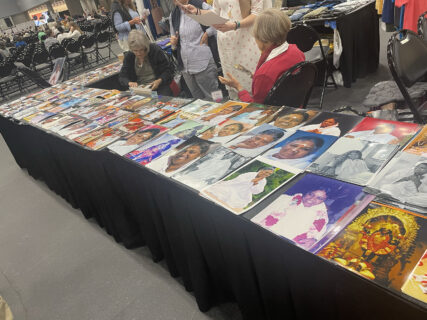 Photos of Amma are displayed for sale, Wednesday, Aug. 7, 2024, at Javits Convention Center in New York. (RNS photo/Richa Karmarkar)