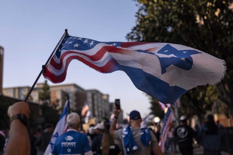 A pro-Israel supporter waves a flag while marching outside the University of Southern California campus in Los Angeles, May 8, 2024. (AP Photo/Jae C. Hong)