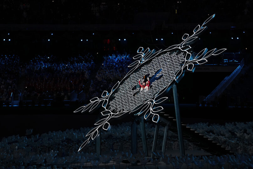 China's athletes Dinigeer Yilamujian and Zhao Jiawen prepare to light the cauldron during the opening ceremony of the 2022 Winter Olympics, Friday, Feb. 4, 2022, in Beijing. (AP Photo/Petr David Josek)