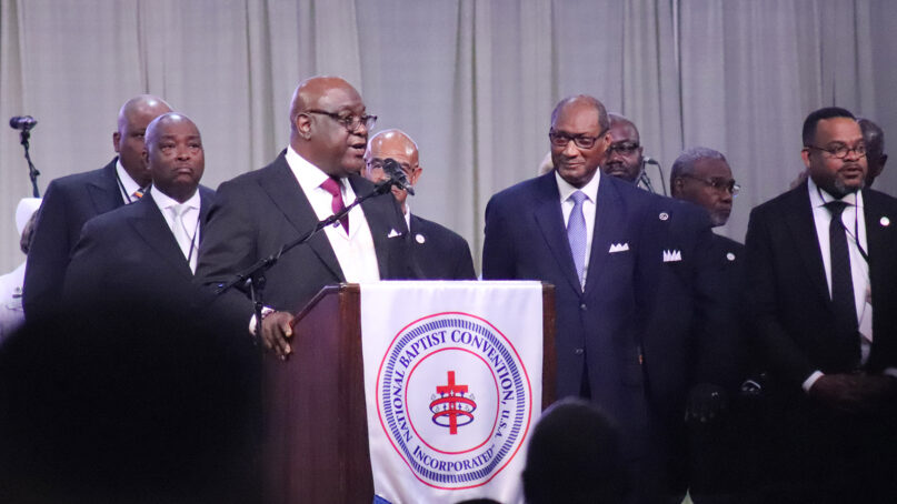 The Rev. Boise Kimber, center left, president-elect of NBCUSA, addresses the end of the National Baptist Convention, USA, Inc. annual meeting, Thursday, Sept. 5, 2024, at the Baltimore Convention Center in Baltimore, Maryland. The Rev. Jerry Young, center right, outgoing NBCUSA president, listens to Kimber. (RNS photo/Adelle M. Banks)