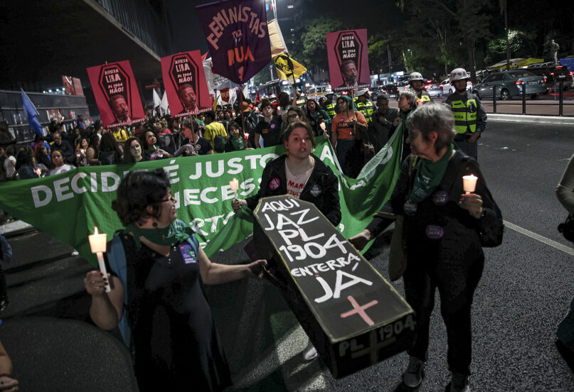 Abortion rights activists carry a coffin, signifying the death of an anti-abortion bill in Congress, as they march to protest the bill in Sao Paulo, Brazil, Thursday, June 27, 2024. (AP Photo/Tuane Fernandes)