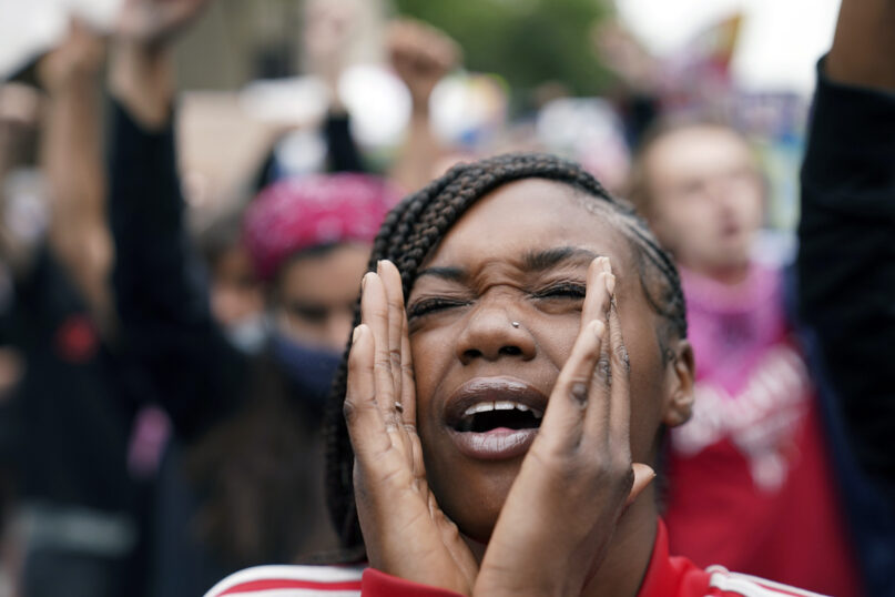 A woman speaks during a protest on Sept. 23, 2020, in Louisville, Ky. A grand jury indicted one officer on criminal charges six months after Breonna Taylor was fatally shot by police in Kentucky. The lack of more charges led to many demonstrations across the nation. (AP Photo/John Minchillo)