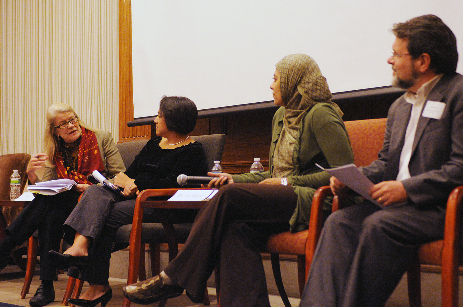 Professor Diana Eck, far left, talks with panelists during an event. Photo courtesy Ellie Pierce