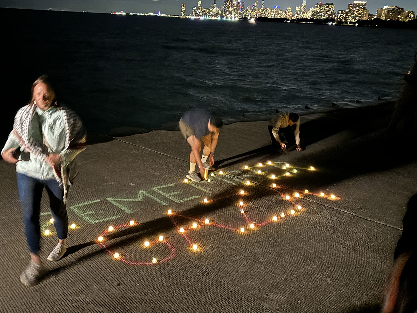 People add lights to the words "Remember Gaza" during a vigil at Montrose Harbor, Tuesday, Aug. 20, 2024, in Chicago. (RNS photo/Bob Smietana)