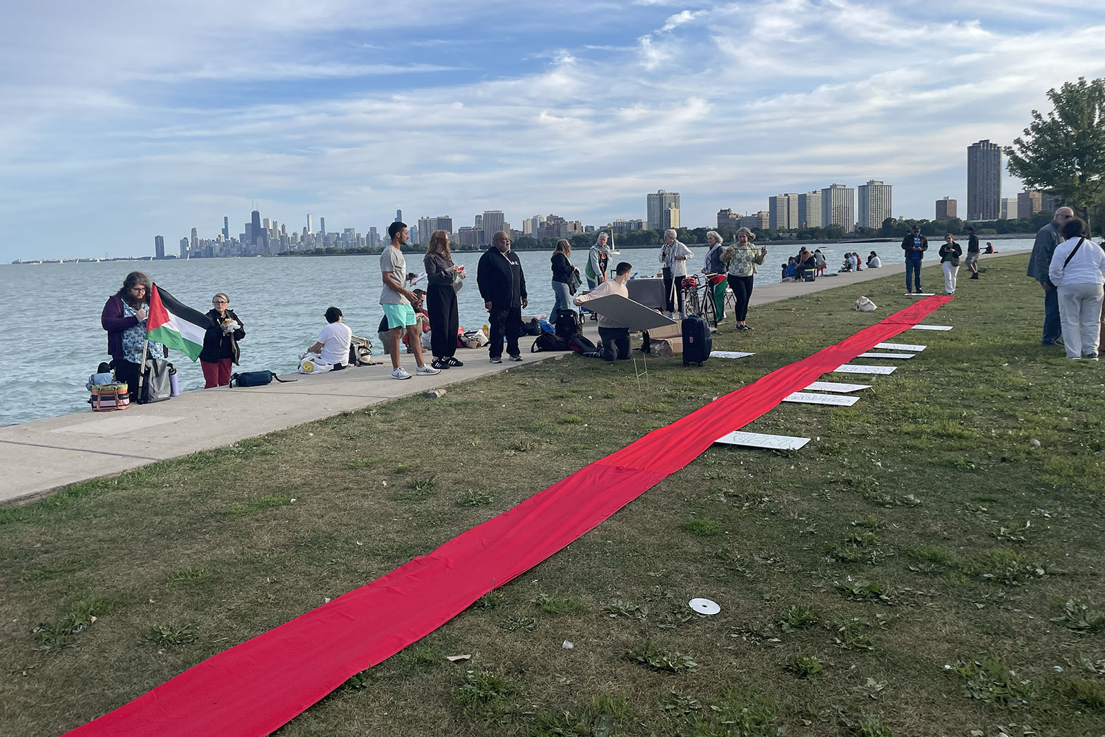 A red ribbon illustrates the U.S. military budget during a vigil to remember those killed in Gaza, at Montrose Harbor, Tuesday, Aug. 20, 2024, in Chicago. (RNS photo/Reina Coulibaly)