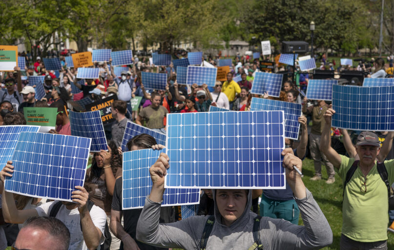 Activists display prints replicating solar panels during a rally to mark Earth Day at Lafayette Square, Washington, April 23, 2022. (AP Photo/Gemunu Amarasinghe, File)