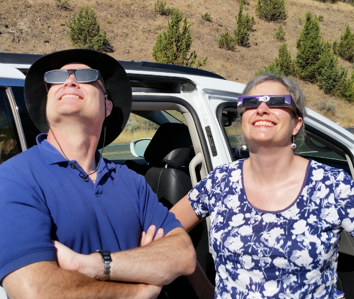 Deborah Haarsma, right, observes the 2017 solar eclipse alongside her brother. (Courtesy photo)