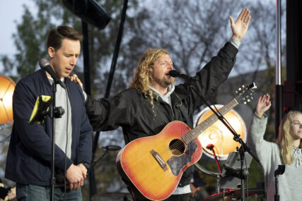 Christian musician Sean Feucht, right, prays with Sen. Josh Hawley, R-Mo., left, during a rally at the National Mall in Washington, Sunday, Oct. 25, 2020. (AP Photo/Jose Luis Magana)