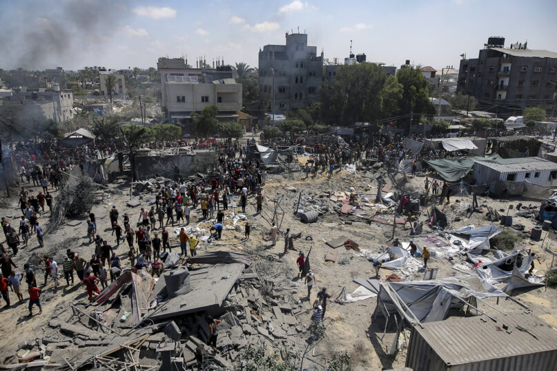 Palestinians inspect the damage at a site hit by an Israeli bombardment on Khan Younis, southern Gaza Strip, July 13, 2024. (AP Photo/Jehad Alshrafi, File)