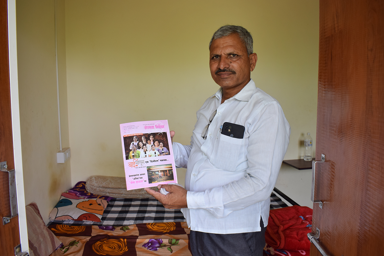 Social activist Shankar Kanase holds a magazine with stories about interfaith couples, at his safe house in the Pimpri village of Maharashtra, India, June 3, 2024. (Photo by Priyadarshini Sen)