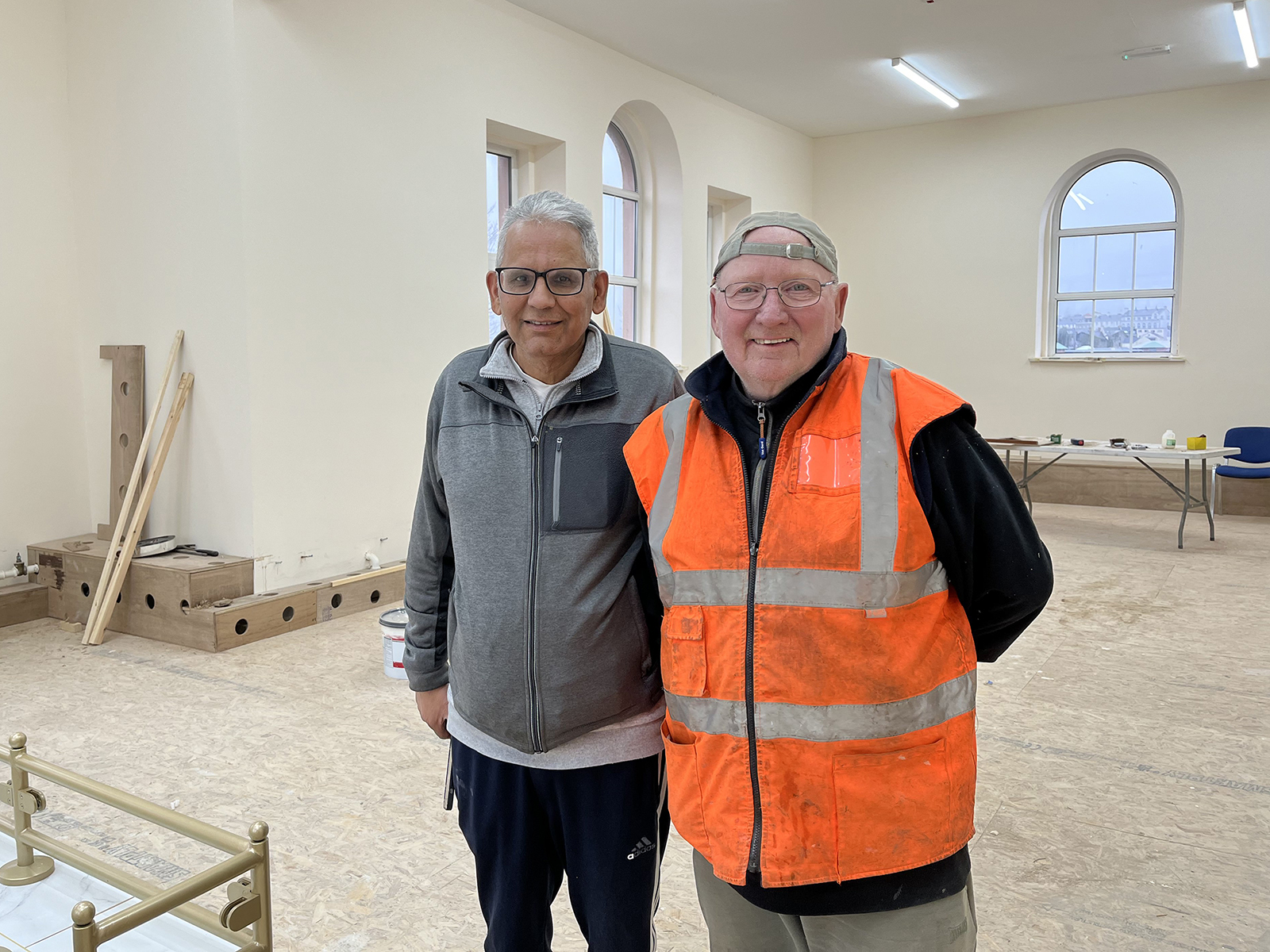 Amerjit Singh, left, and a volunteer at the gurdwara in Londonderry, Northern Ireland, ahead of its reopening. (Photo by Trisha Mukherjee)