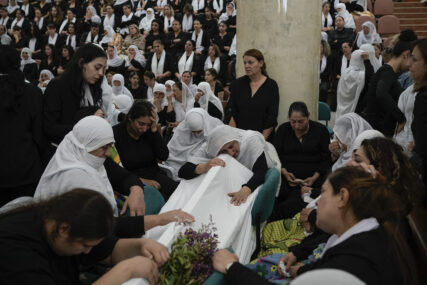 Members of the Druze community mourn during the funeral of their relatives at the village of Majdal Shams in the Israeli-controlled Golan Heights, Sunday, July 28, 2024. A rocket strike at a soccer field in the village has killed at least 12 children and teens. It's the deadliest strike on an Israeli target along the country's northern border since the fighting between Israel and the Lebanese militant group Hezbollah began. (AP Photo/Leo Correa)