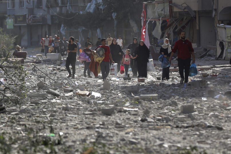 Palestinians leave their homes after Israeli bombardment on Gaza City, Oct. 30, 2023. (AP Photo/Abed Khaled)