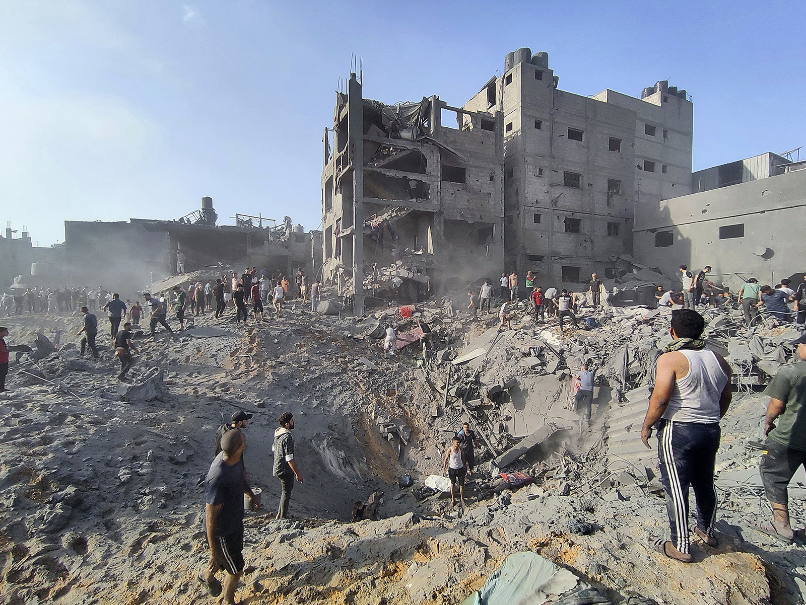 FILE - Palestinians inspect the damage of buildings destroyed by Israeli airstrikes on Jabaliya refugee camp on the outskirts of Gaza City, Tuesday, Oct. 31, 2023. Israel and Hamas have both been accused of breaking the rules of armed conflict. Hamas killed hundreds of civilians and abducted scores more when it attacked southern Israel on Oct. 7. Israel has bombarded Gaza and told more hundreds of thousands of Palestinians to leave their homes. The United Nations says it is collecting evidence of war crimes by all sides. But holding perpetrators to account for it is often difficult. (AP Photo/Abdul Qader Sabbah, File)