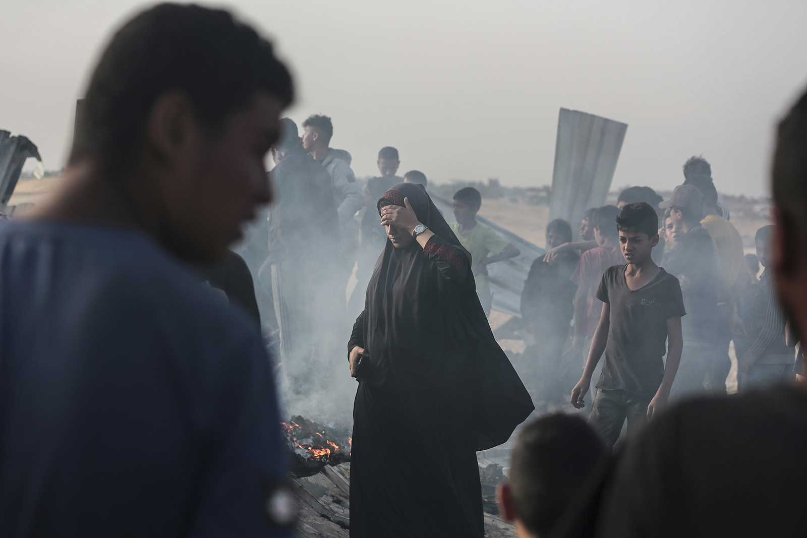 Palestinians look at the destruction after an Israeli strike where displaced people were staying in Rafah, Gaza Strip, May 27, 2024. Palestinian health workers said Israeli airstrikes killed at least 35 people in the area. (AP Photo/Jehad Alshrafi)