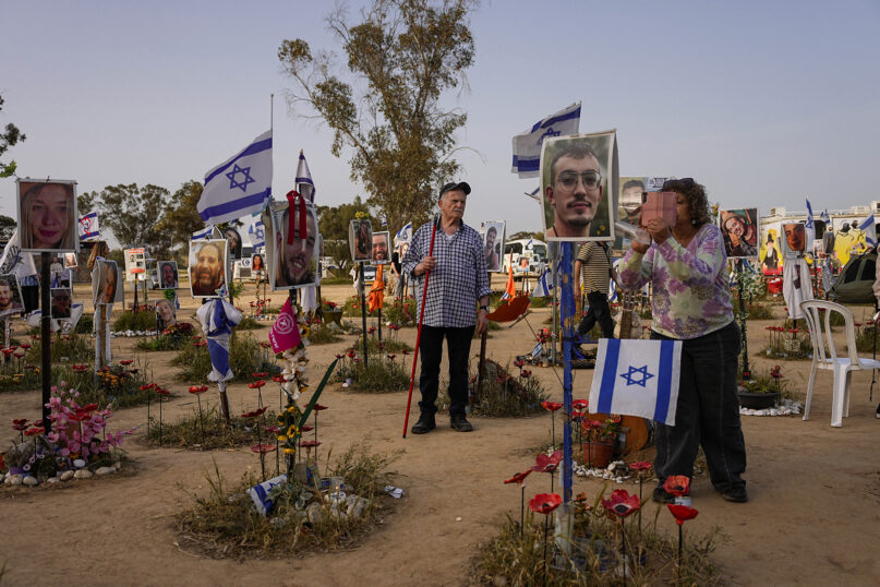 People visit the site where revelers were killed and kidnapped during the Oct. 7 cross-border attack by Hamas militants at the Nova music festival near Kibbutz Reim, southern Israel, March 27, 2024. (AP Photo/Ohad Zwigenberg)