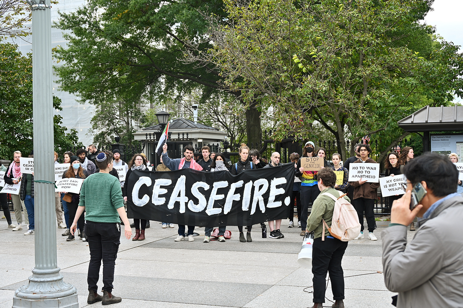 Signs and banners called for ceasefire as demonstrators joined together in opposition to the ongoing conflict in the Middle East. The group gathered Monday afternoon, Oct. 16, 2023 in front of the White House. RNS photo by Jack Jenkins