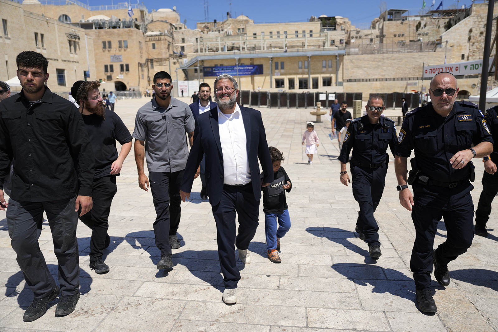 Israel's far-right National Security Minister Itamar Ben-Gvir, center, flanked by his security detail, approaches the entrance to Jerusalem's most sensitive holy site, the Temple Mount, in Jerusalem's Old City, Tuesday, Aug. 13, 2024. (AP Photo/Ohad Zwigenberg)