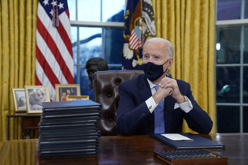 President Joe Biden waits to sign his first executive order in the Oval Office of the White House, Jan. 20, 2021, in Washington. As one of his first acts, Biden offered a sweeping immigration overhaul that would provide a path to U.S. citizenship for the estimated 11 million people who are in the United States illegally. (AP Photo/Evan Vucci, File)