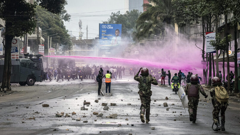 Police fire water canons during a protest in Nairobi, Kenya, Tuesday, July 16, 2024. Police in Kenya hurled tear gas canisters to break up protests on Tuesday in Nairobi, and other major cities, while protesters accuse the president of poor governance and call for his resignation despite his dismissal of nearly the entire Cabinet last week. (AP Photo/Ed Ram)