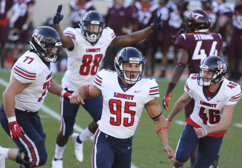 Liberty's Alex Barbir (95) celebrates kicking the game-winning field goal in the last second of the fourth quarter of an NCAA college football game against Virginia Tech, Saturday, Nov. 7 2020, in Blacksburg, Va. Liberty won 38-35. (Matt Gentry/The Roanoke Times via AP, Pool)