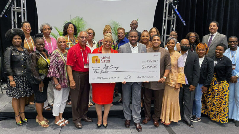 The Lott Carey Baptist Foreign Mission Society accepts a $1 million donation, Tuesday, Aug. 13, 2024, in Memphis, Tenn., from Alfred Street Baptist Church in Alexandria, Virginia.  Lott Carey president the Rev. Gina Stewart, center left, and the Rev. Howard-John Wesley, center right, of Alfred Street Baptist Church, hold the check. (Photo courtesy Lott Carey)