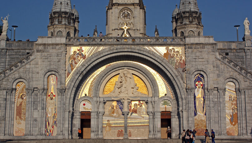 The facade of the Basilica of Our Lady of the Rosary in Lourdes, France, has mosaics by Fr. Marko Ivan Rupnik. (Photo by Lawrence OP/Flickr/Creative Commons)