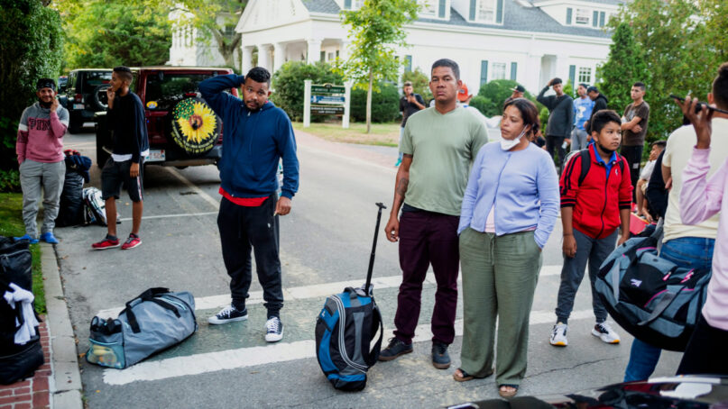 Immigrants gather with their belongings outside St. Andrews Episcopal Church, Wednesday Sept. 14, 2022, in Edgartown, Mass., on Martha's Vineyard. Florida Gov. Ron DeSantis on Wednesday flew two planes of immigrants to Martha's Vineyard, escalating a tactic by Republican governors to draw attention to what they consider to be the Biden administration's failed border policies. (Ray Ewing/Vineyard Gazette via AP)