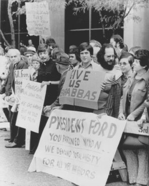 A crowd outside a Pittsburgh hotel where President Ford was addressing a transportation conference holds signs protesting his decision to grant a pardon to former President Richard Nixon for any crimes he may have committed while Chief Executive. RNS photo courtesy of the Presbyterian Historical Society